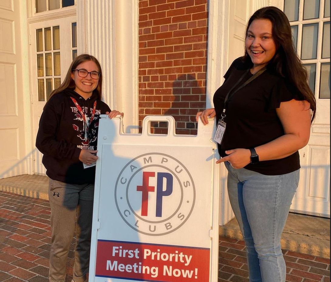 Leaders Keira Conner and Abigail Waldorf welcome new members to the first First Priority meeting of the school year.