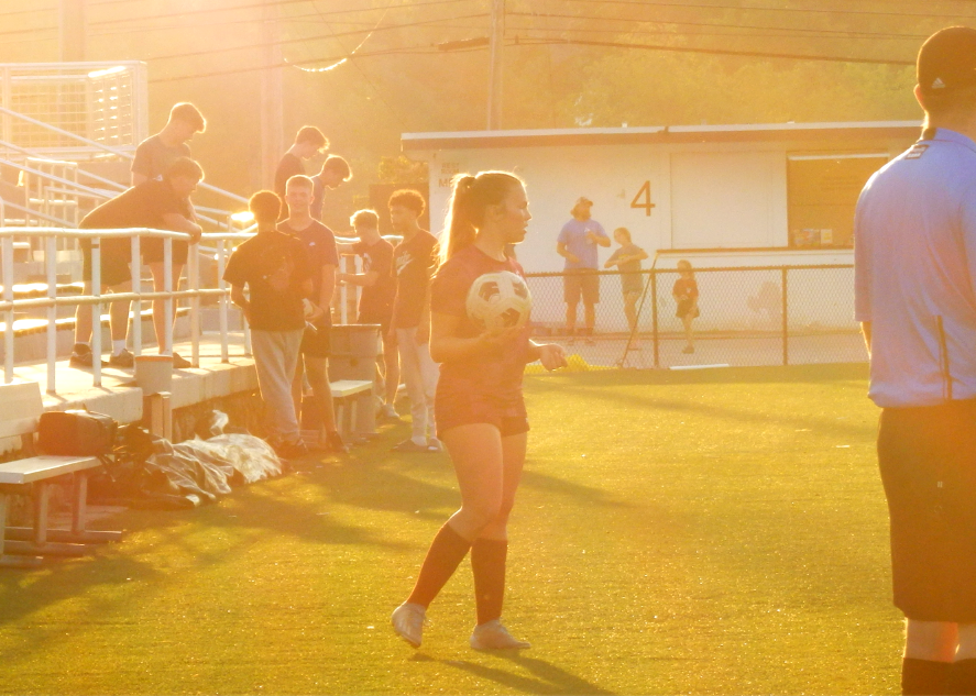 Nila Proffitt searches for her teammates from the sideline as she prepares to throw the ball.