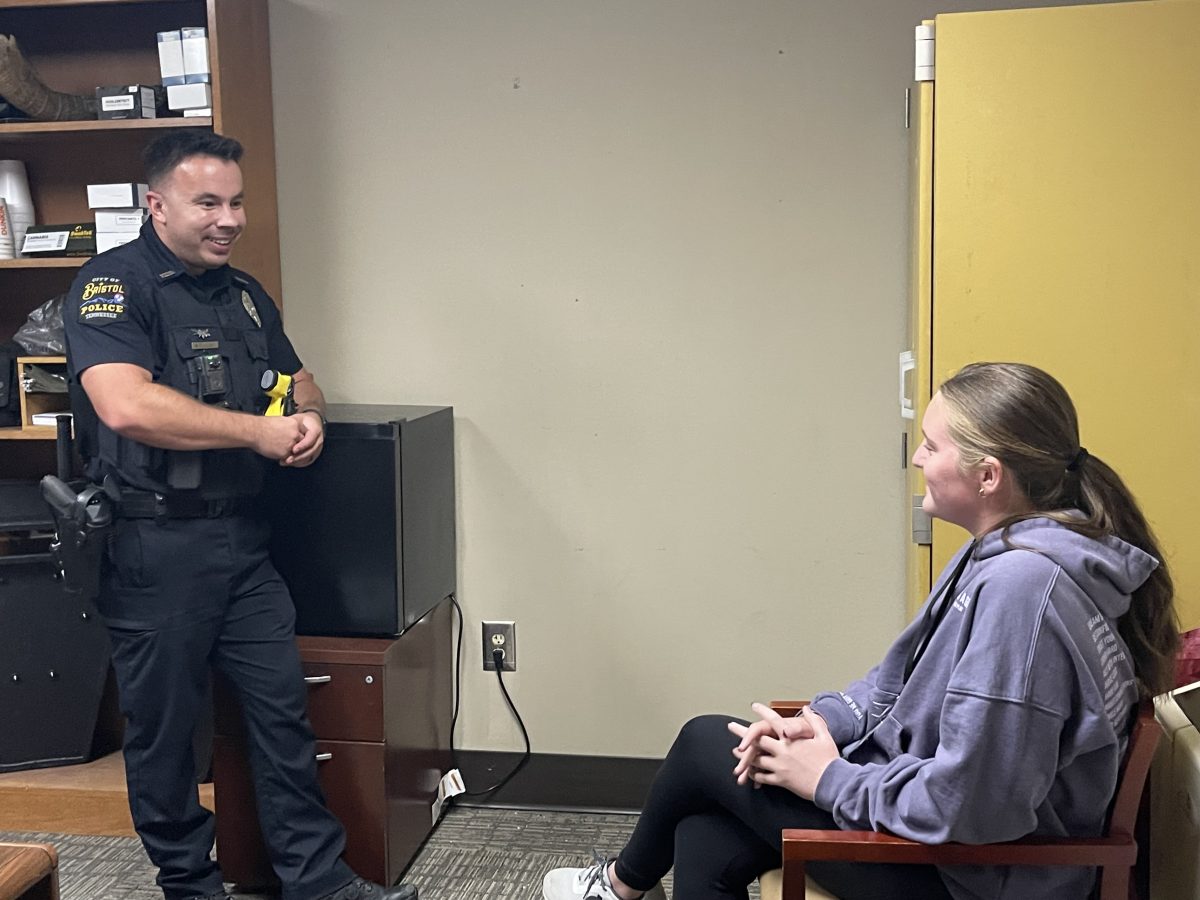 SRO Officer Aaron Colley speaking with sophomore Averie Cuddy.