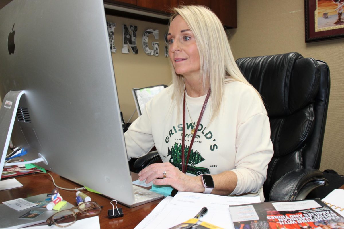 Principal Kim Kirk working at her desk.