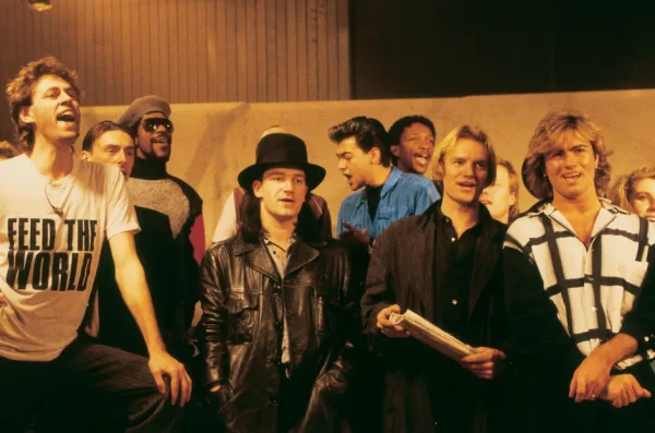 BandAid members George Michael (left), Sting (middle), and Bono (right) rehearsing before the Feed The World fundraiser / iStock