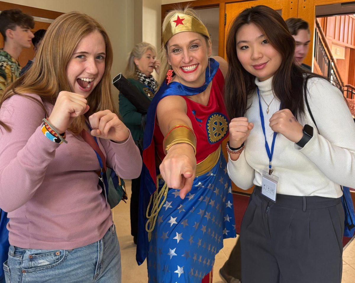 Interact Club members Anna Grace Hodges (left) and Lily Chen (right) meet with Amelia Stansell (middle).