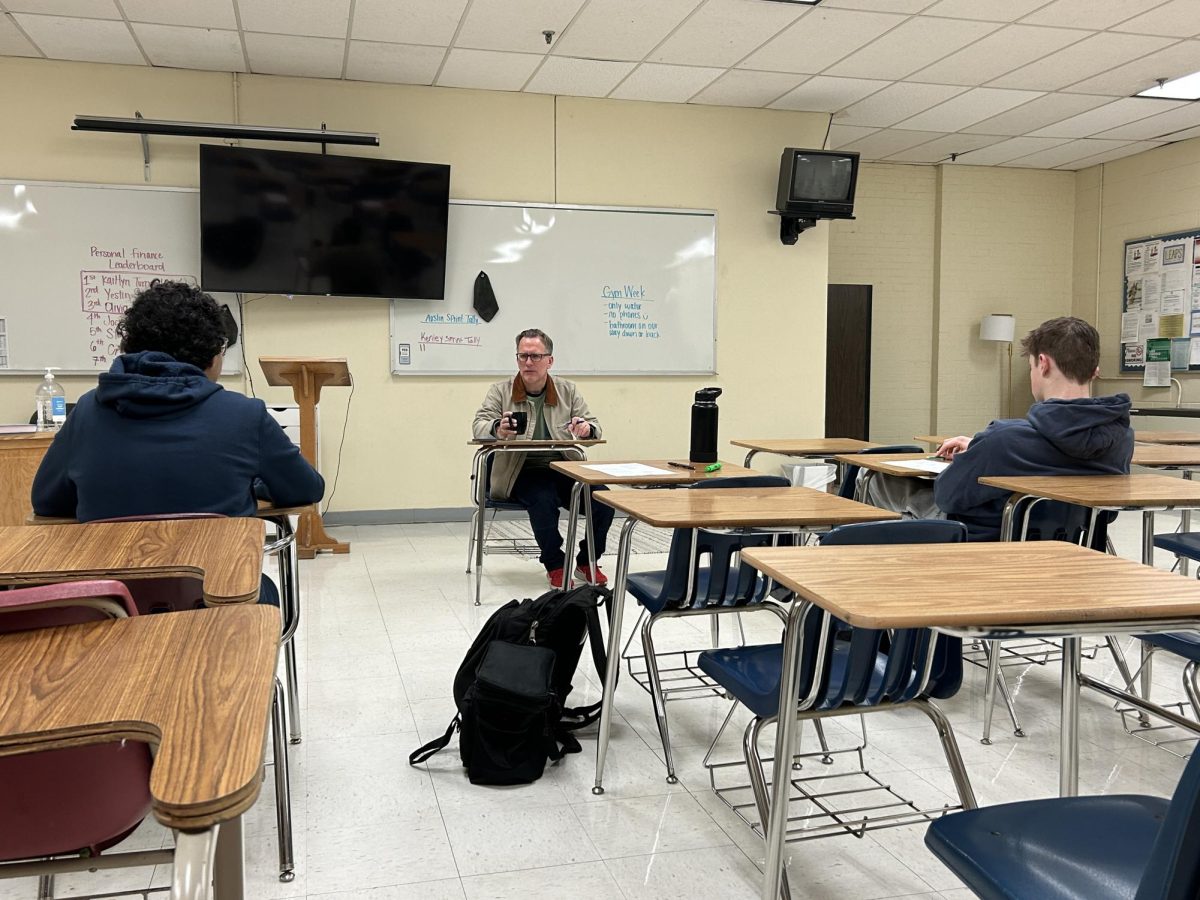 Mr. Davis guides freshmen Moaaz Khalil and Penn Story on an ACT review sheet.