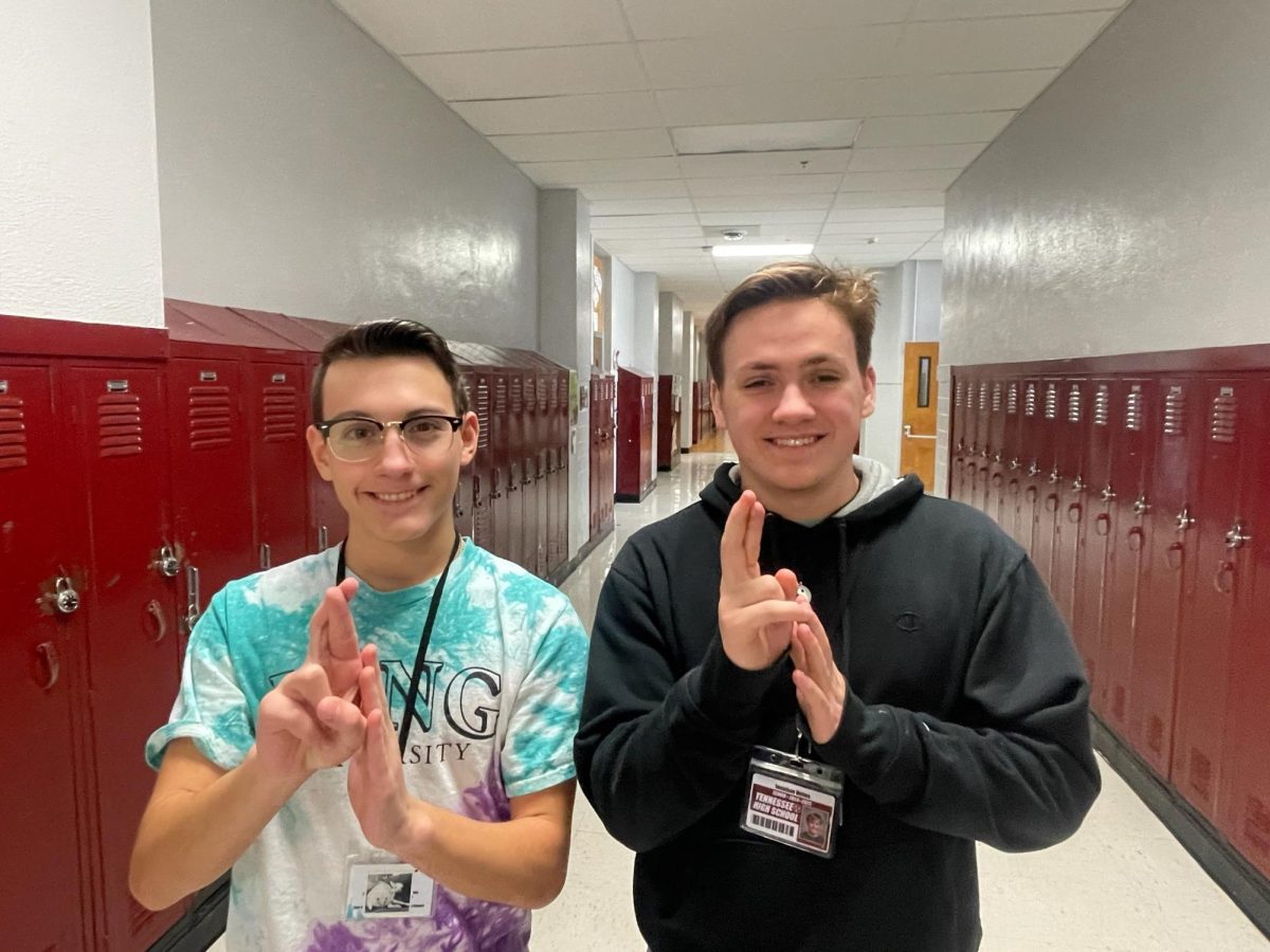 ASL Vice President Jonah Cunningham (junior) and member Jonathan Helms (senior) sign "rocket"