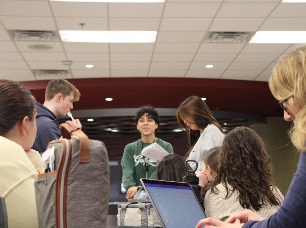 Co-presidents, senior Ricardo Cortez and sophomore Lily Chen, lead a homeroom meeting discussing the club's spring fundraiser.