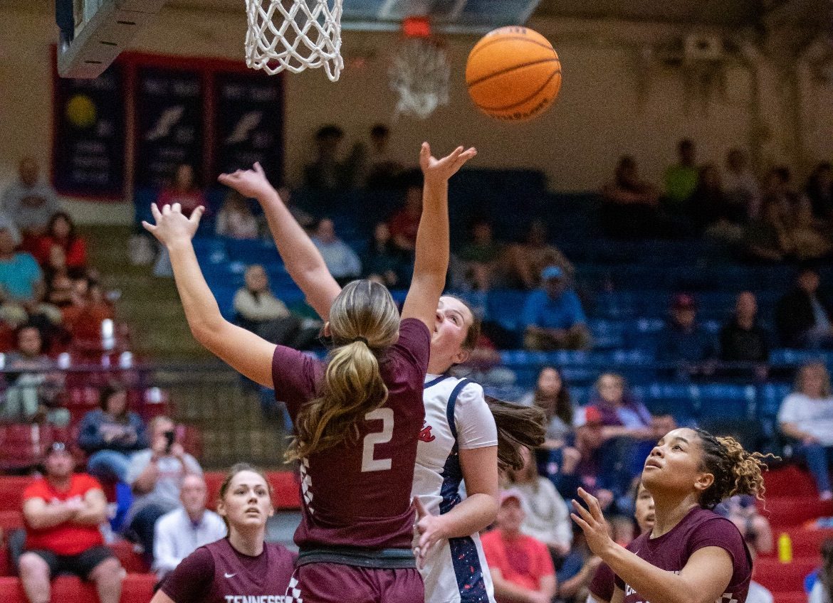 The Lady Vikings fight for the rebound against the Lady Patriots.