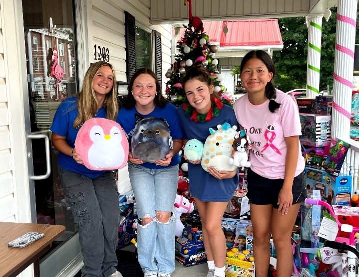 Members of Civinettes dropping off donations for the Johnia Berry Toy Drive at Christmas in July. 