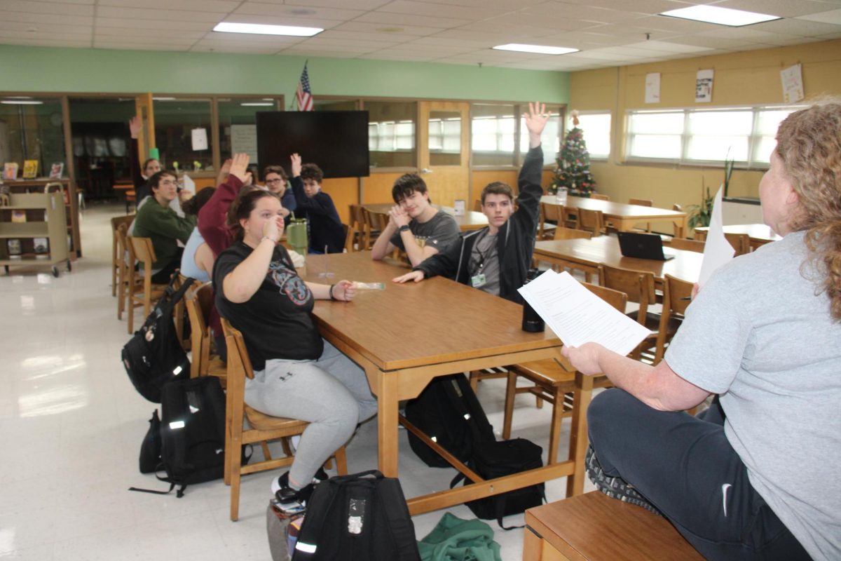 Split into two teams, members of the Scholar's Bowl practice answering questions.