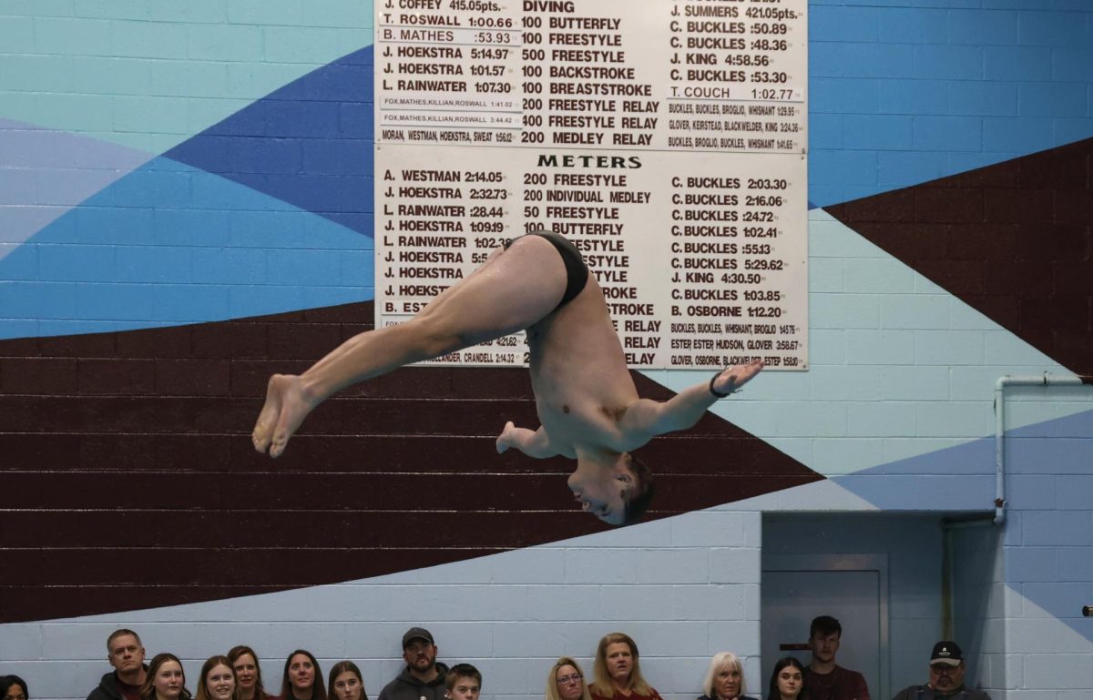 Senior Jonathan Helms diving on senior night in January. 