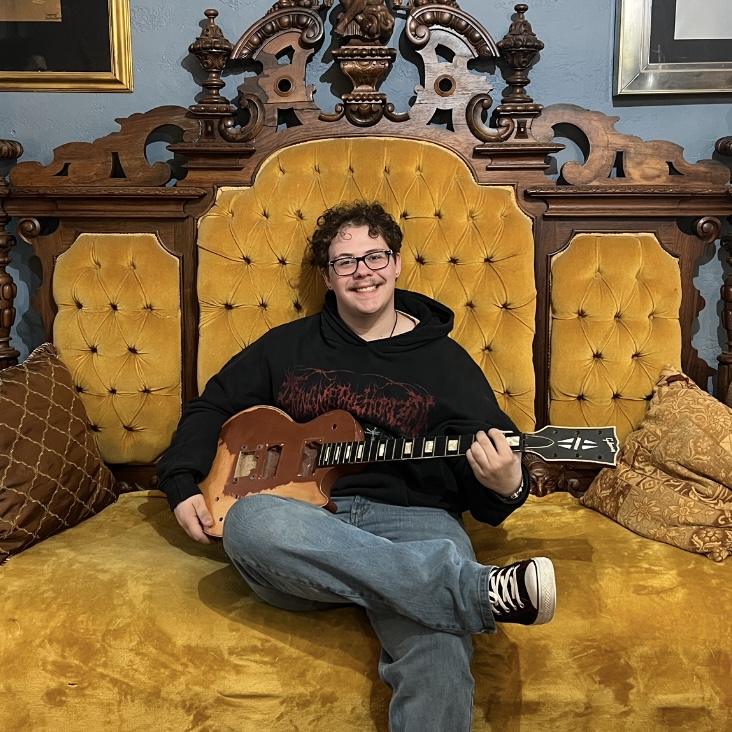 Cameron with one of his many guitars.