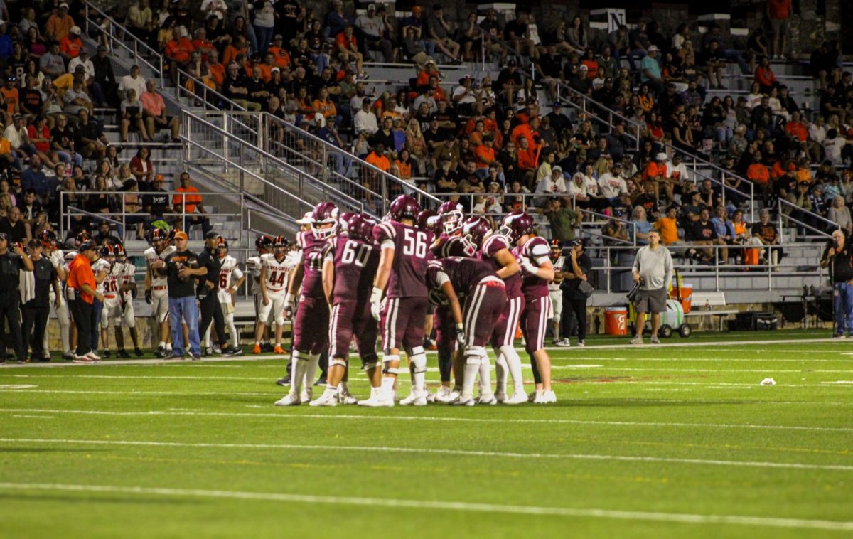 The Viking offense huddles around quarterback Jack Richardson and awaits the play call.