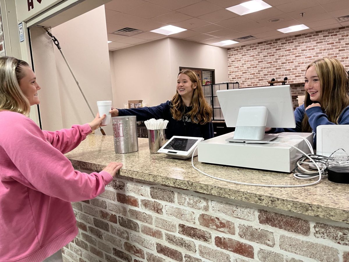 A student purchases a drink from the School Store.