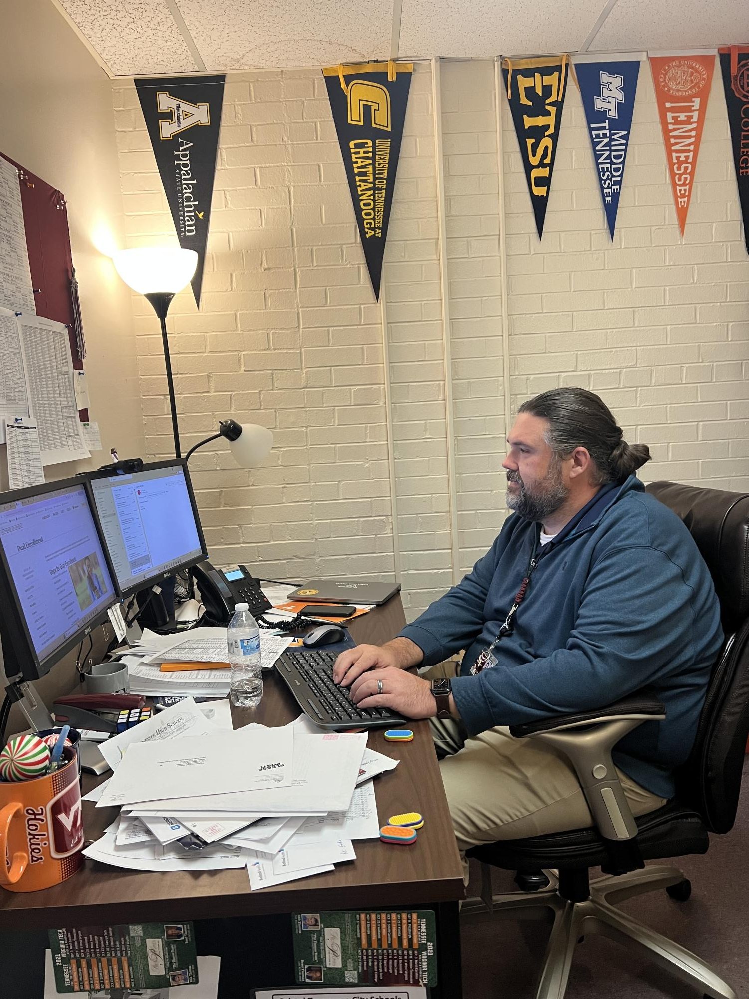 Senior Guidance Counselor, Reese Henry, working on paperwork for high school seniors.