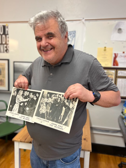 Matthew Hayes holds up cast photos from the silent film "Arms and the Woman," which was a part of his father's collection of artifacts from his time working in the movies. His father was Wallace Hayes, an actor and talented lighting technician who later moved East in his dreams of becoming a family man.