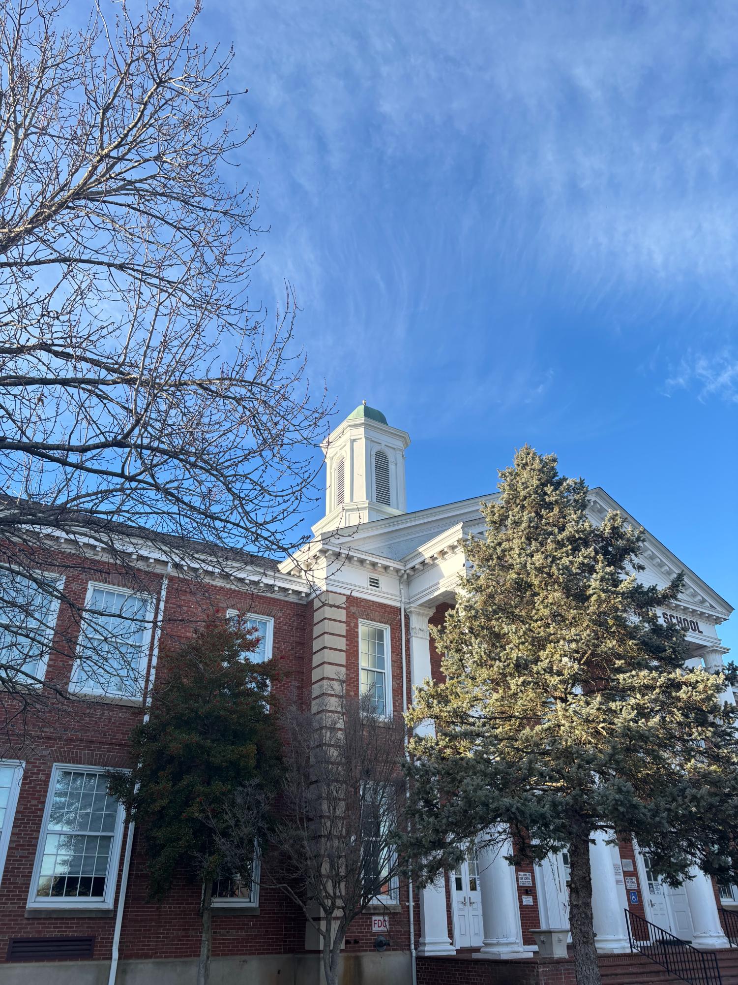 The restored cupola has been freshly painted and includes the finial from the original design.