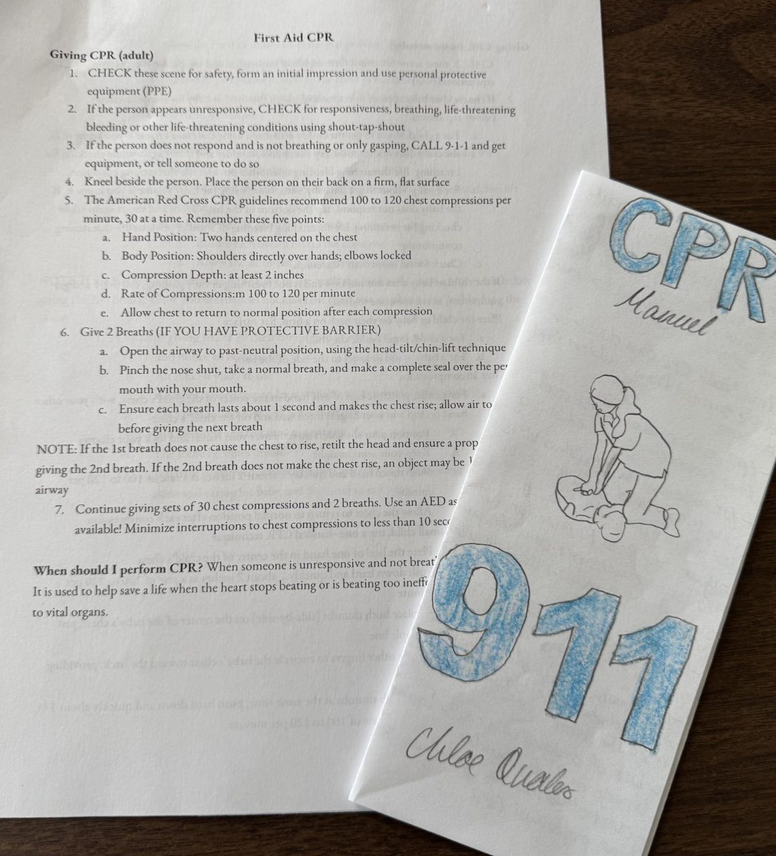 An official first aid CPR manual and the front of a CPR manual created by Chloe Quales in wellness class.