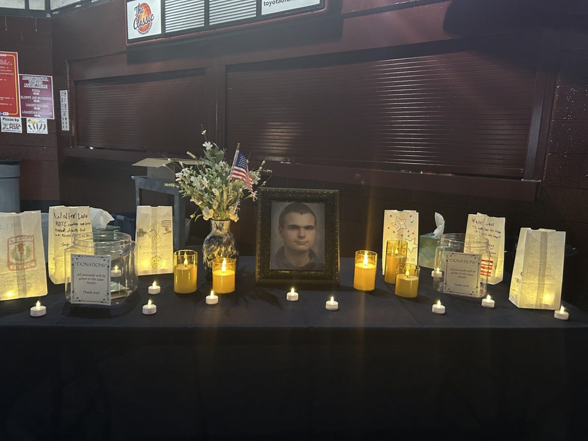 The opening of the Viking Hope Walk featured a table recognizing sophomore Walter Lane, filled with photos, flowers, and bags to honor him. 