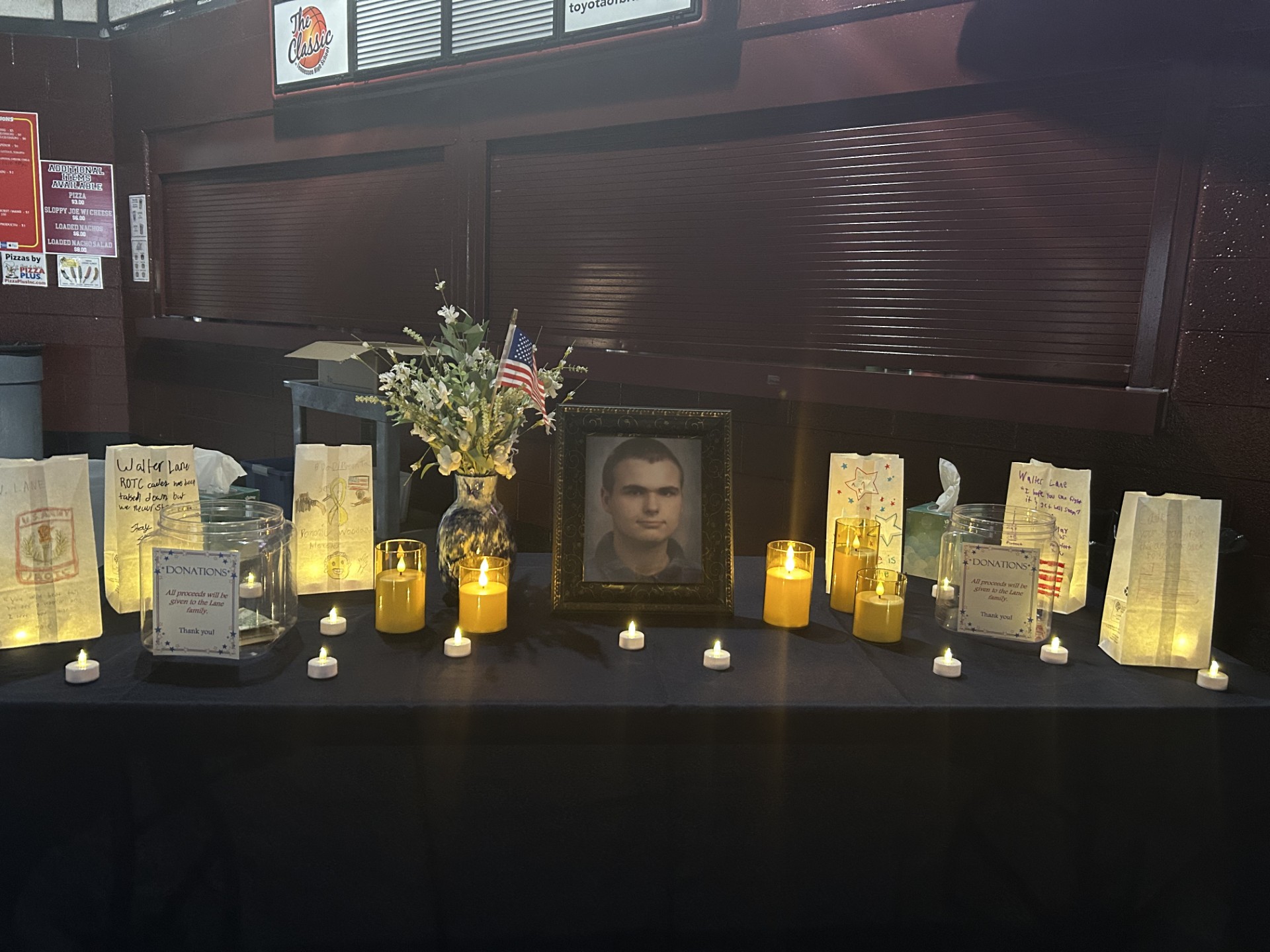 The opening of the Viking Hope Walk featured a table recognizing sophomore Walter Lane, filled with photos, flowers, and bags to honor him. 