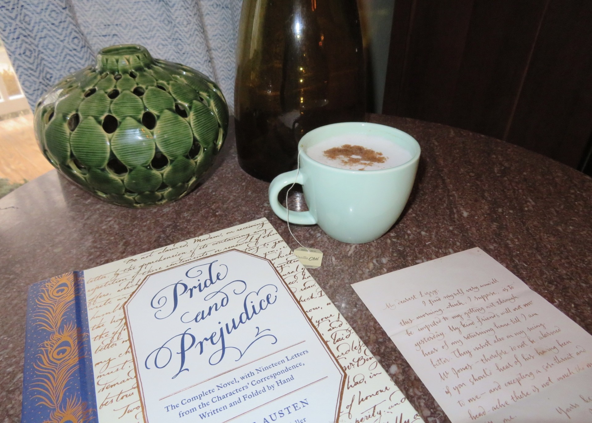 Pride and Prejudice novel featuring letters from character correspondence, alongside my favorite tea. 