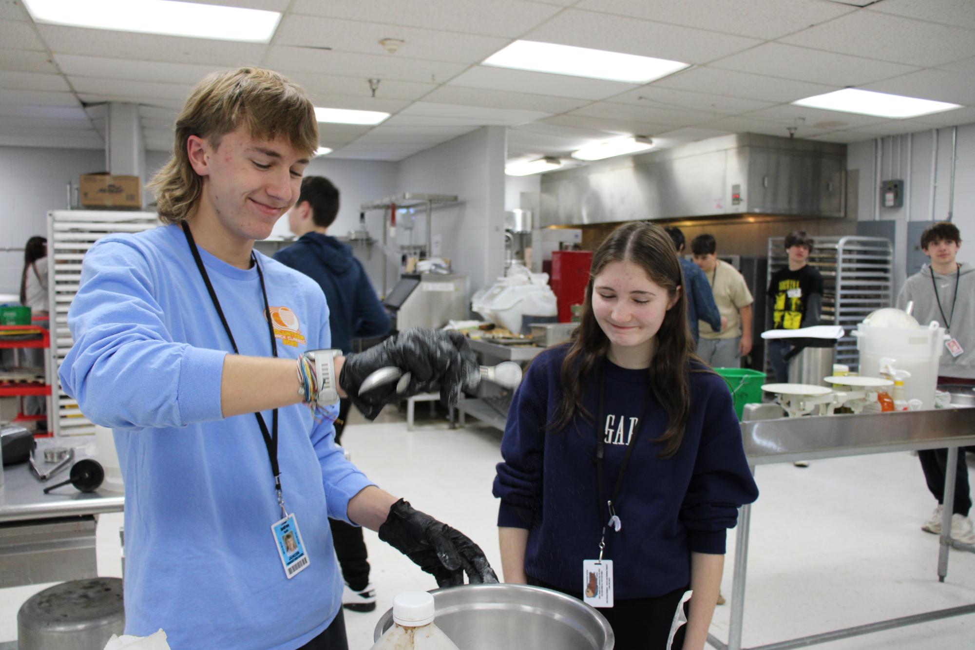 Juniors Andrew Sells and Callie Baker mixing the ingredients for their cookie dough in Culinary Arts I.