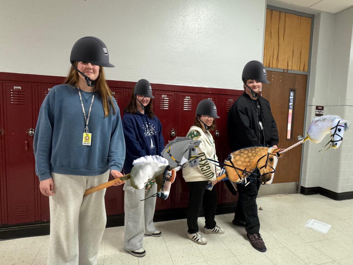 Four members of the TN High hobby horsing team from left to right, including Kaylyn Conley, Ava Mayo, Kaylee Reese, and James Colley.