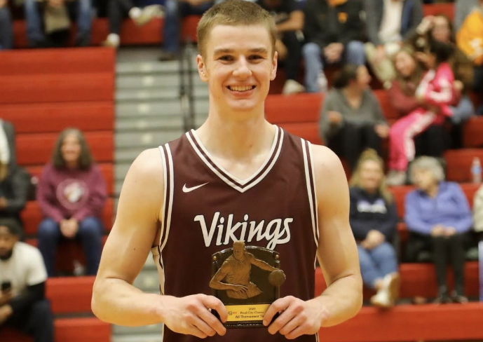 Reed Miller smiling for a picture after receiving his award for all-tournament.